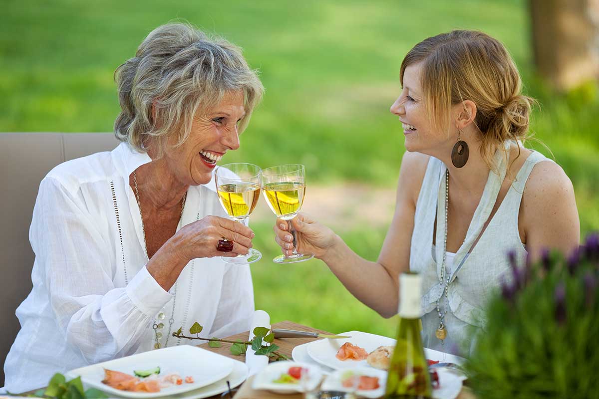 mother and daughter enjoying wine