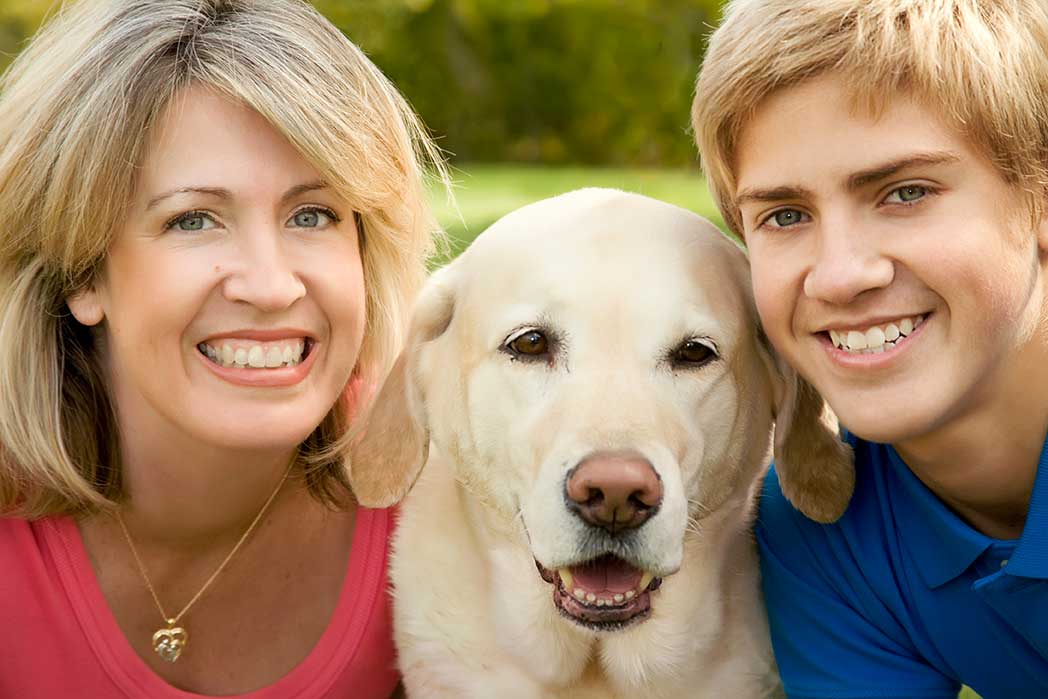 mother and son taking with photo with their dog